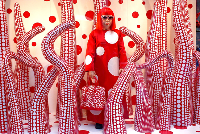 Yayoi Kusama in the window of Luis Vuitton boutique at the opening of her own collection, 2012 | Article on ArtWizard